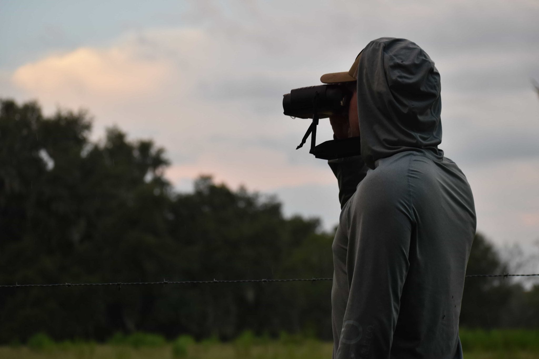 man looking through scope
