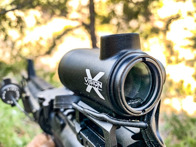 What Does Cowitness Mean?- ZRF1 red dot sight on gun in woods Cowitness blog