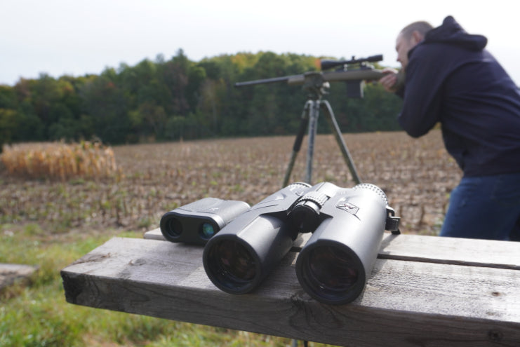 Rangefinding binoculars with shooter in background