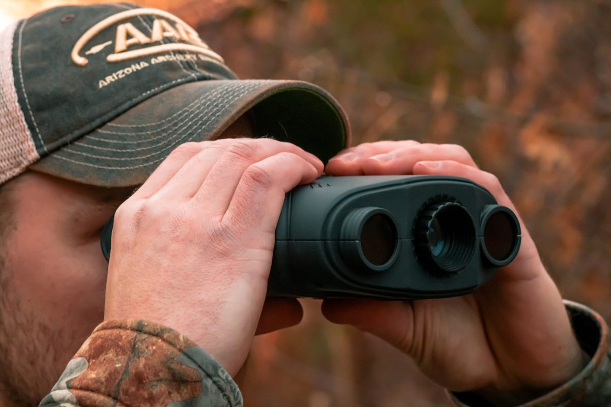 hunter looking through binoculars while mountain lion hunting