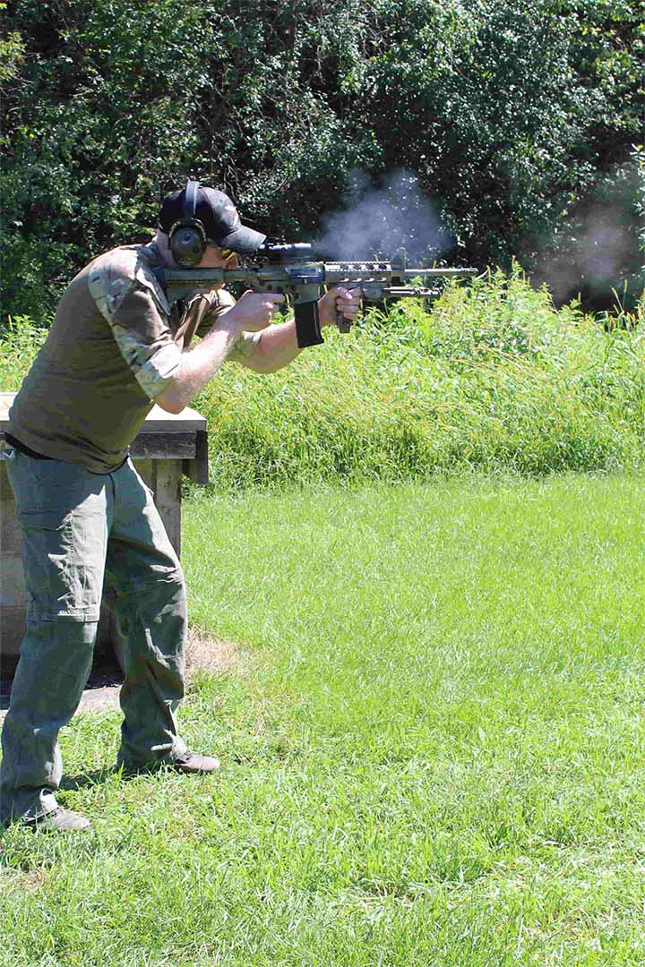 Man firing gun at gun range