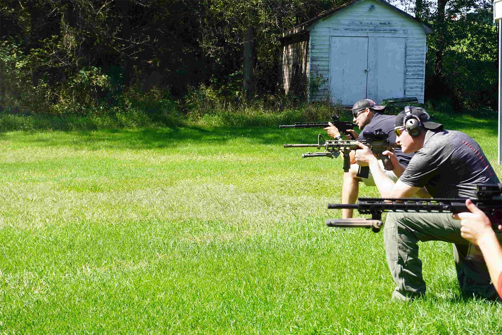 multiple men aiming guns on shooting range